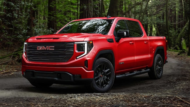Side view profile of the 2023 GMC Sierra 1500 driving on the road.