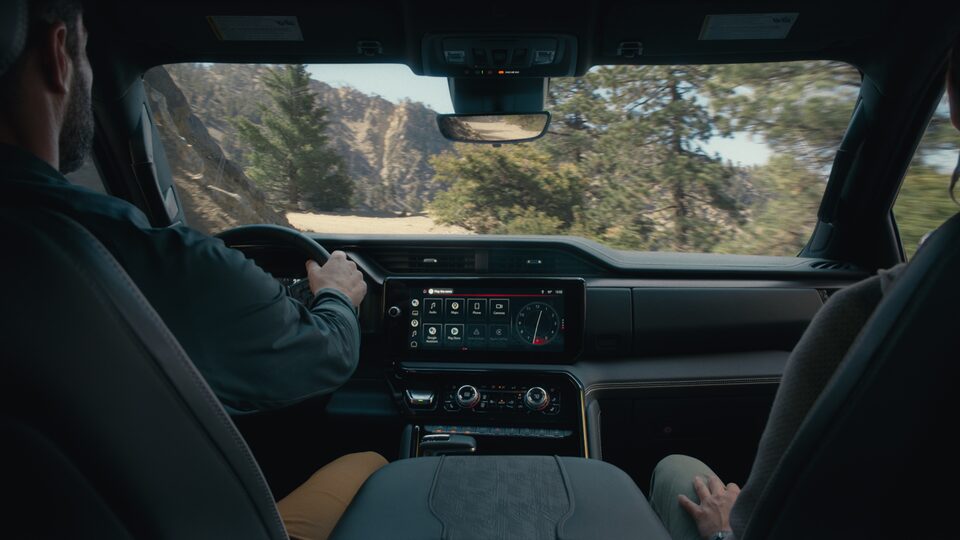 2023 GMC Sierra AT4X interior dashboard featuring the steering wheel and centre console.