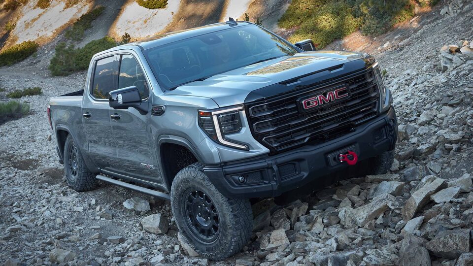 The First Ever 2023 Sierra 1500 AT4X AEV Edition parked on rocky ground.