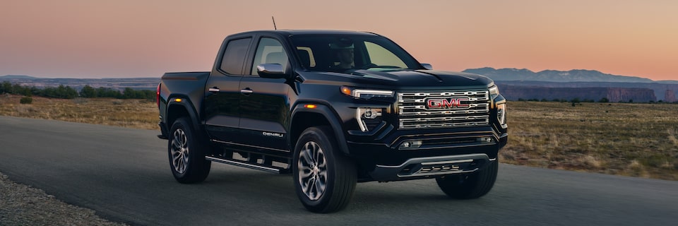 2024 GMC Canyon Denali driving on the road.
