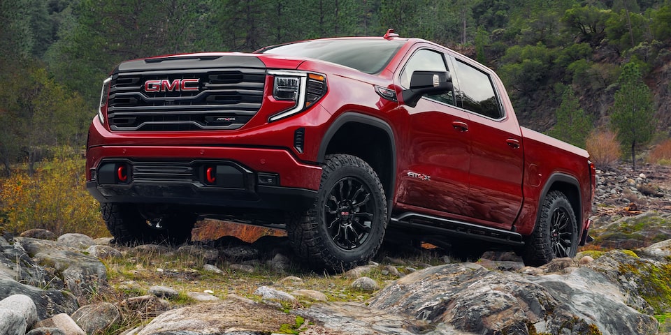 The 2024 GMC Sierra 1500 AT4X on a rocky terrain.