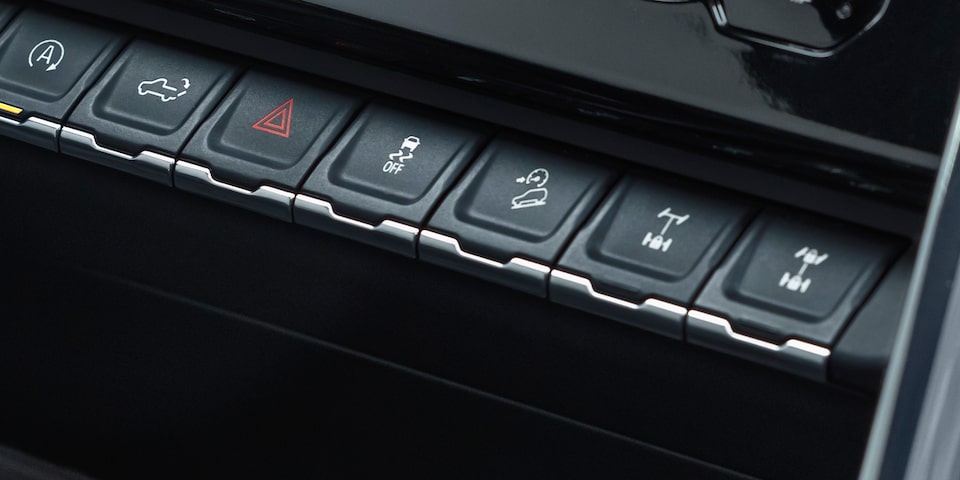 Buttons of the Hill Descent Control feature of the 2024 GMC Sierra 1500 AT4.