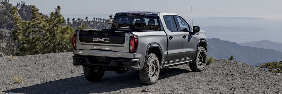 The 2024 GMC Sierra 1500 AT4 overlooking atop a mountainside.