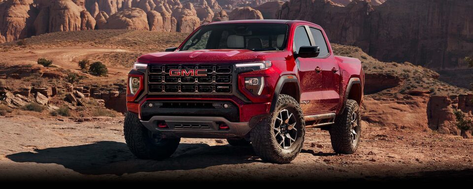 2024 GMC Canyon parked fiercely on top of a rocky canyon.