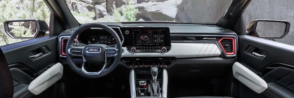The 2025 GMC Canyon AT4 Pickup Truck Front Interior with Steering Wheel and Infotainment System.