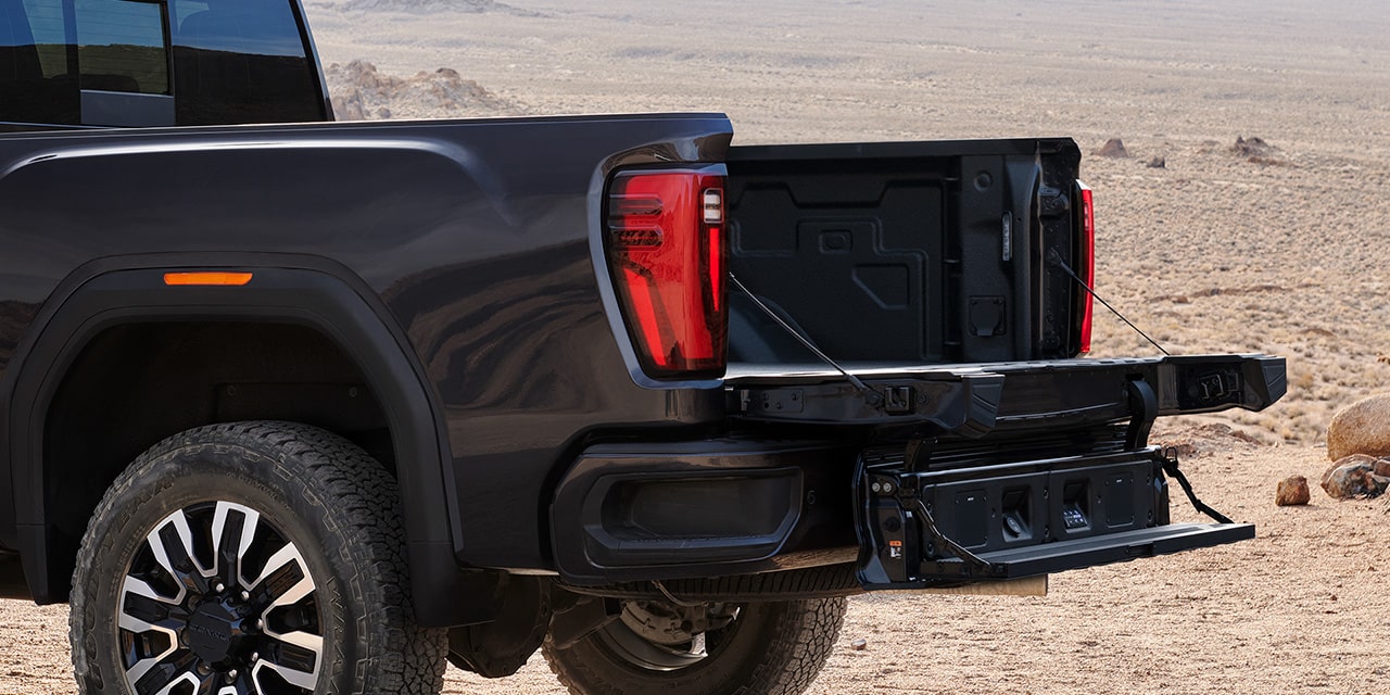 Close-up View of the MultiPro Tailgate with Step Lowered on a 2026 GMC Sierra HD AT4.