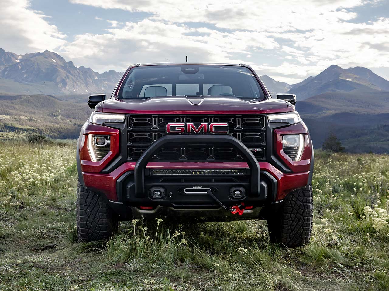 Front view of the 2026 GMC Canyon parked on a grassy field.