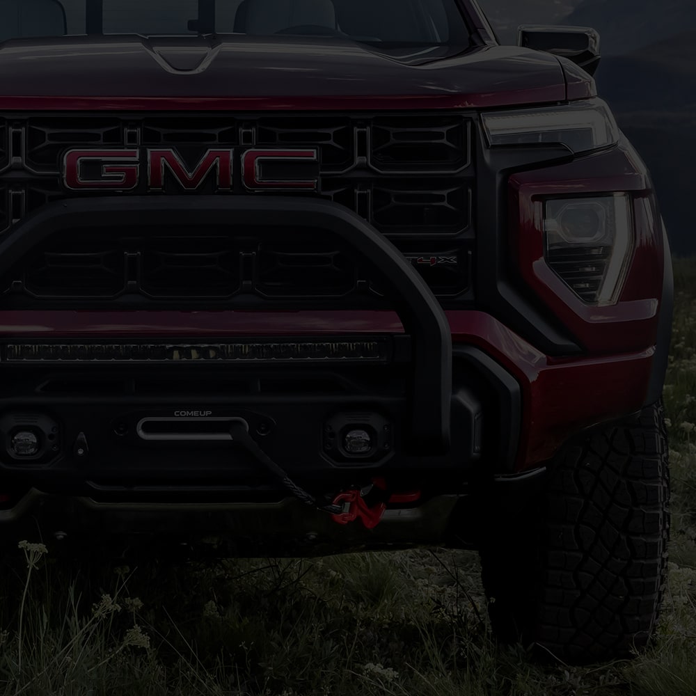 Close up view of the front grille and headlight of the 2026 GMC Canyon.