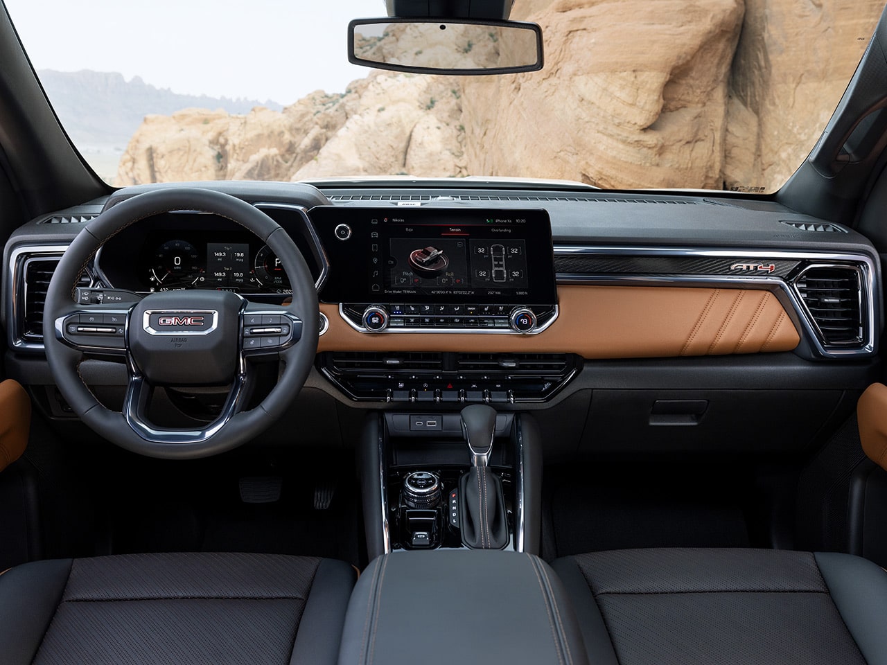 Front interiors of the 2026 GMC Canyon AT4 with Timber interior accents.