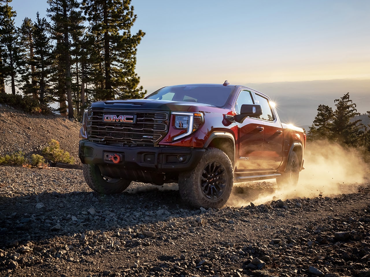 The 2026 GMC Sierra AT4 Speeding Down a Dirt Road with Ease.