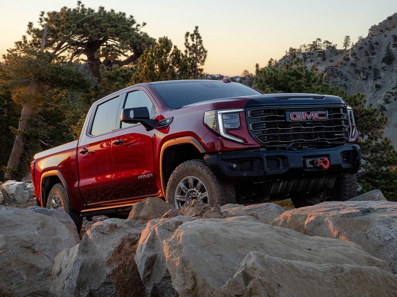 The 2026 GMC Sierra 1500 AT4 Off-Road Truck Driving Over Rough Terrain.