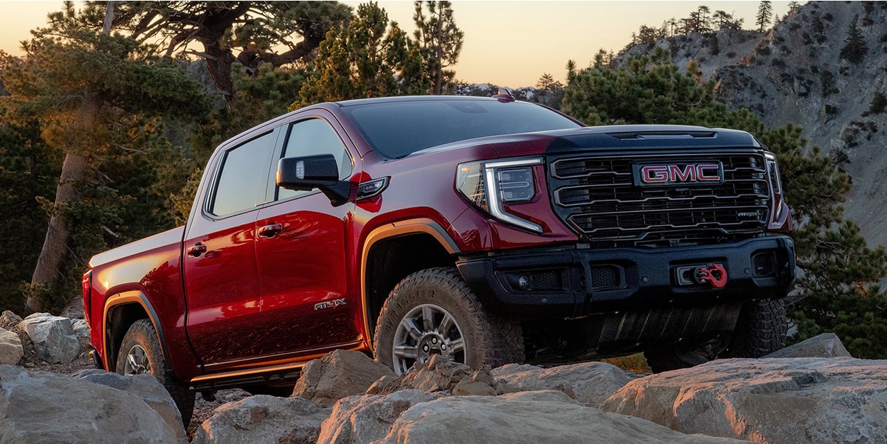 The 2026 GMC Sierra 1500 AT4 Off-Road Truck Driving Over Rough Terrain.