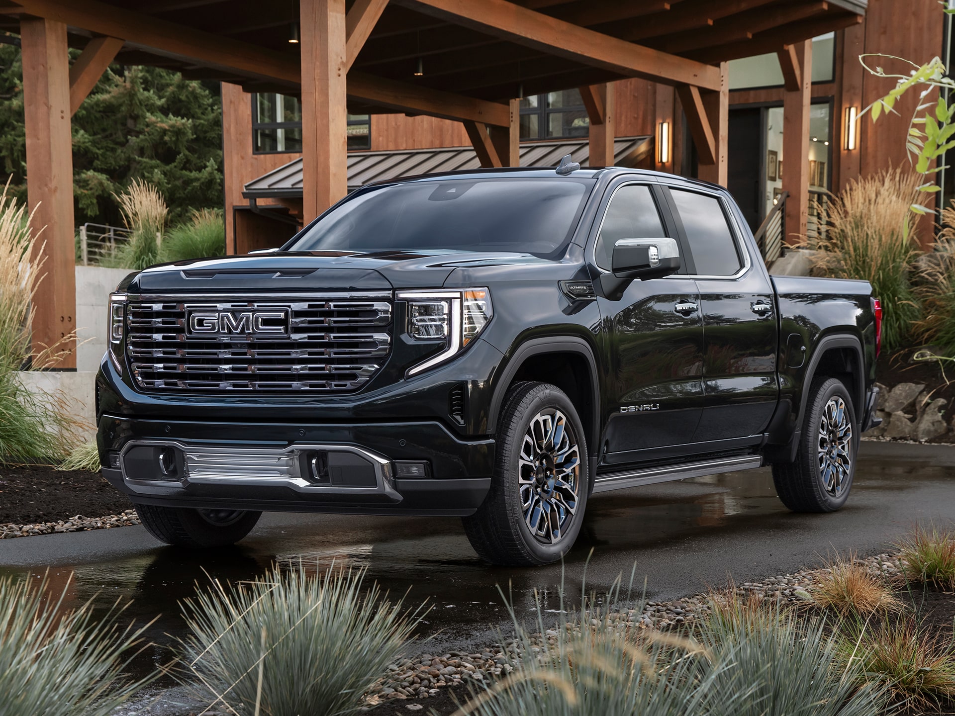 The 2026 GMC Sierra 1500 Parked in the Driveway of a Beautiful Cabin in the Woods.