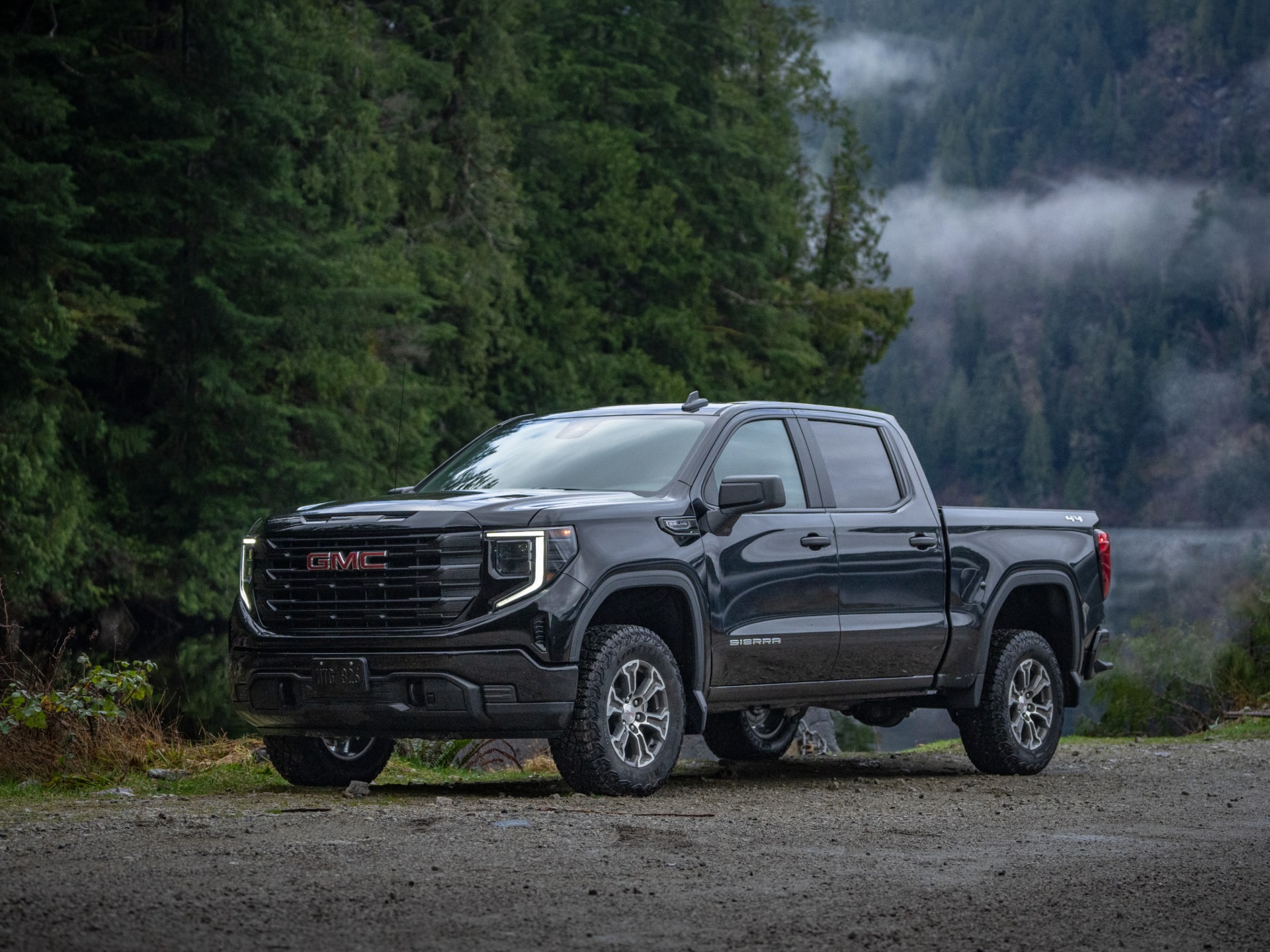 Front Three-Quarters View of a White 2026 GMC Sierra 1500 Pro parked in a Green Valley.