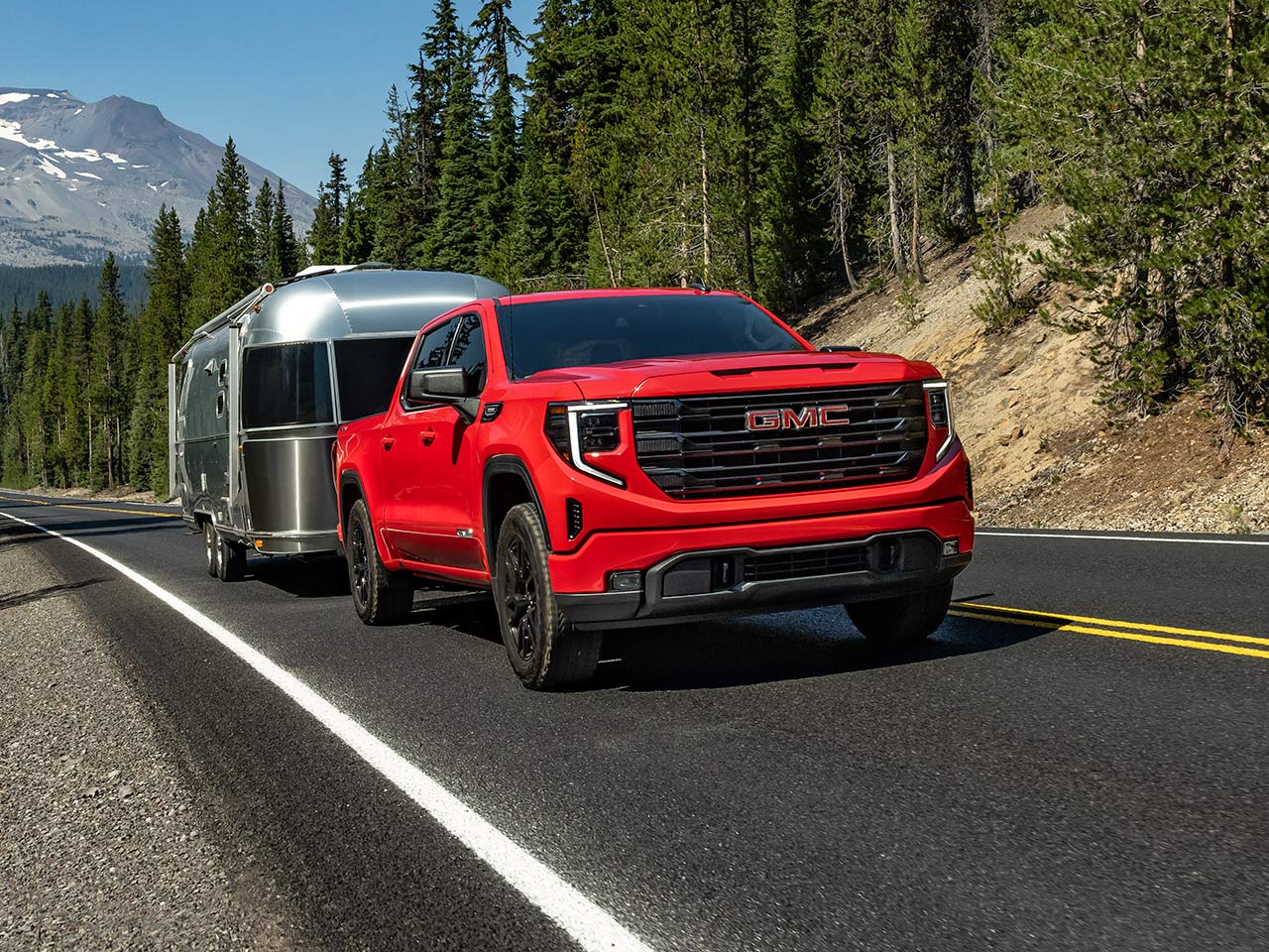 The 2026 GMC Sierra 1500 Towing a Trailer Down the Open Road.