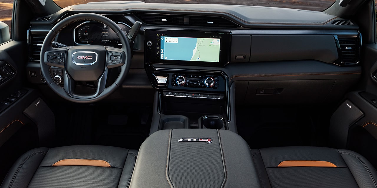 Interior View of Front Seats and the Dashboard in a 2026 GMC Sierra HD AT4.