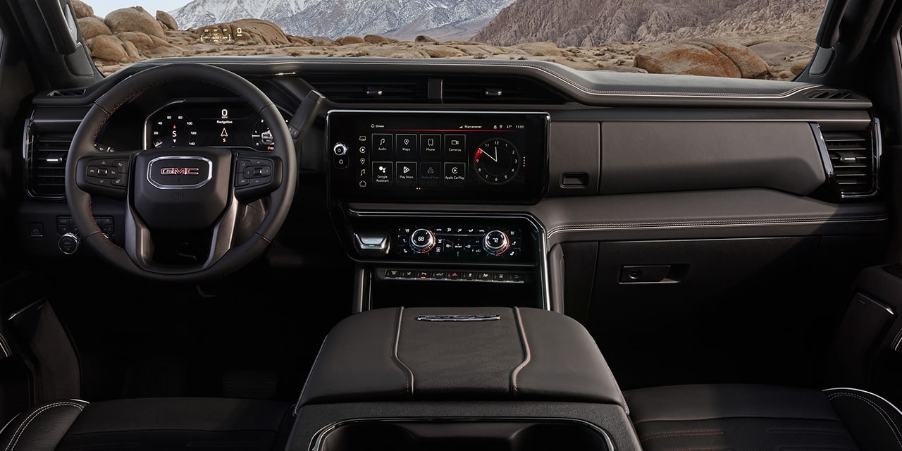 Interior View of Front Seats and the Dashboard in a 2026 GMC Sierra HD AT4.