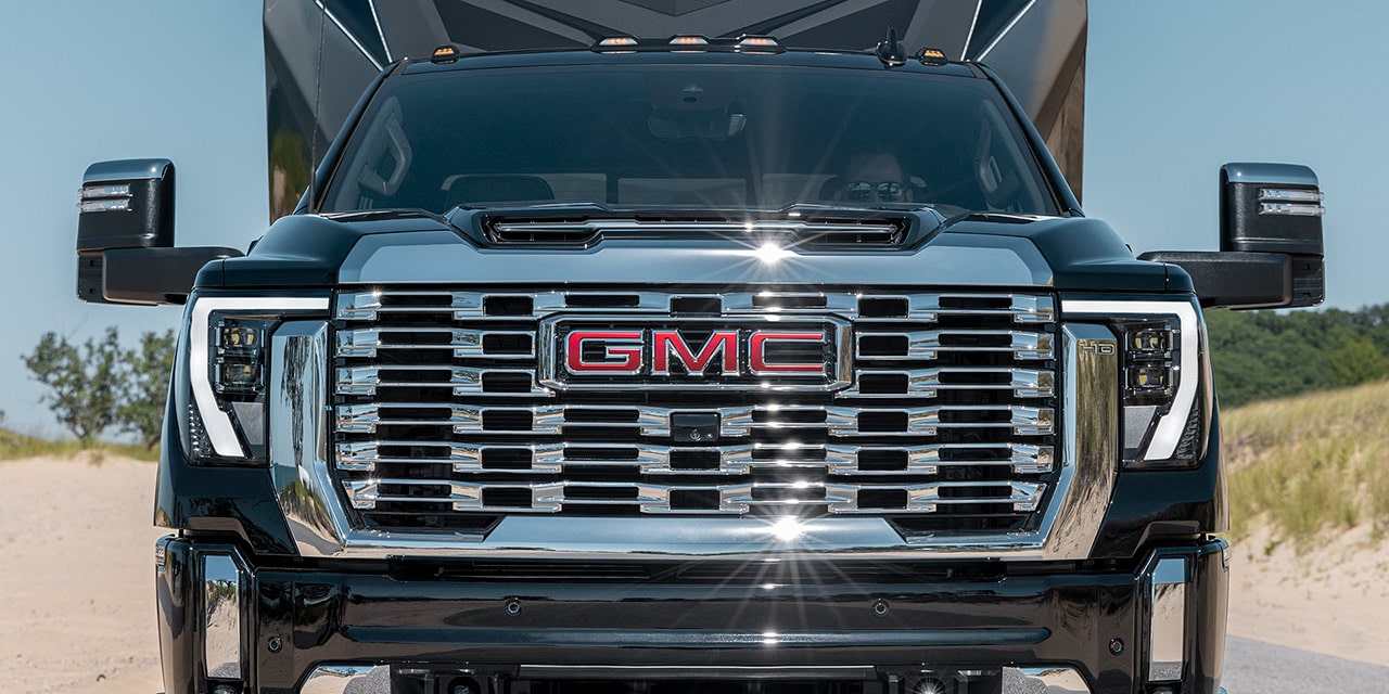 Front View of the Grille on a 2026 GMC Sierra HD Denali Luxury Truck While Hauling a Trailer.