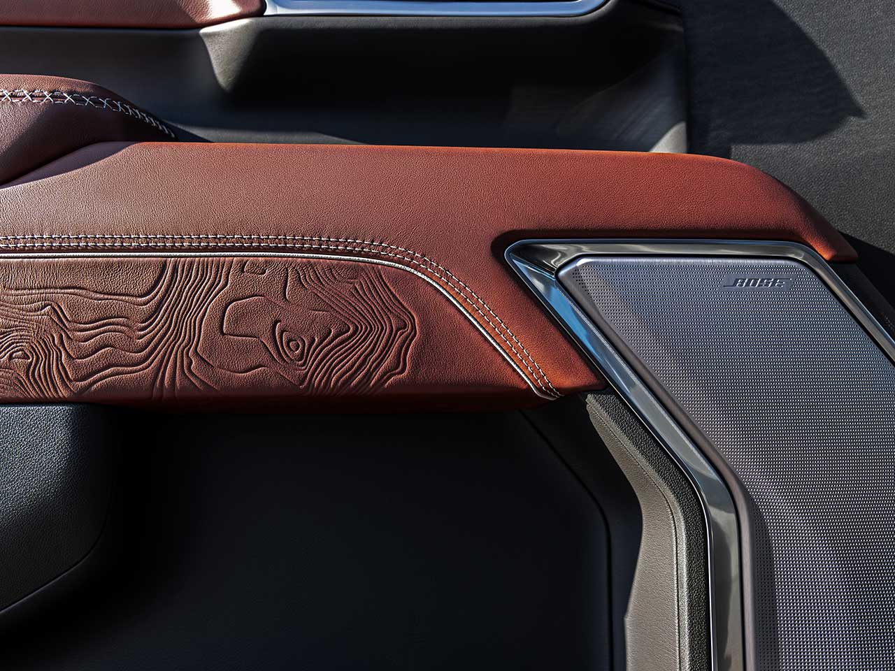 Close-up of the Bose Speaker and Authentic Wood Detailing in the 2026 GMC Sierra HD Denali Luxury Truck.
