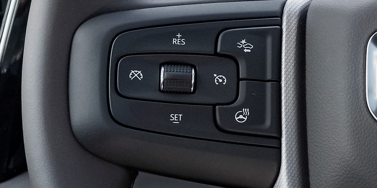 Close-up of the Adaptive Cruise Control with Trailering Controls on the Steering Wheel of the 2026 GMC Sierra HD Pro.