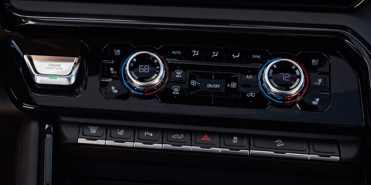 Close-up of the Dual-Zone Automatic Climate Control of the 2026 GMC Sierra HD Pro Truck.