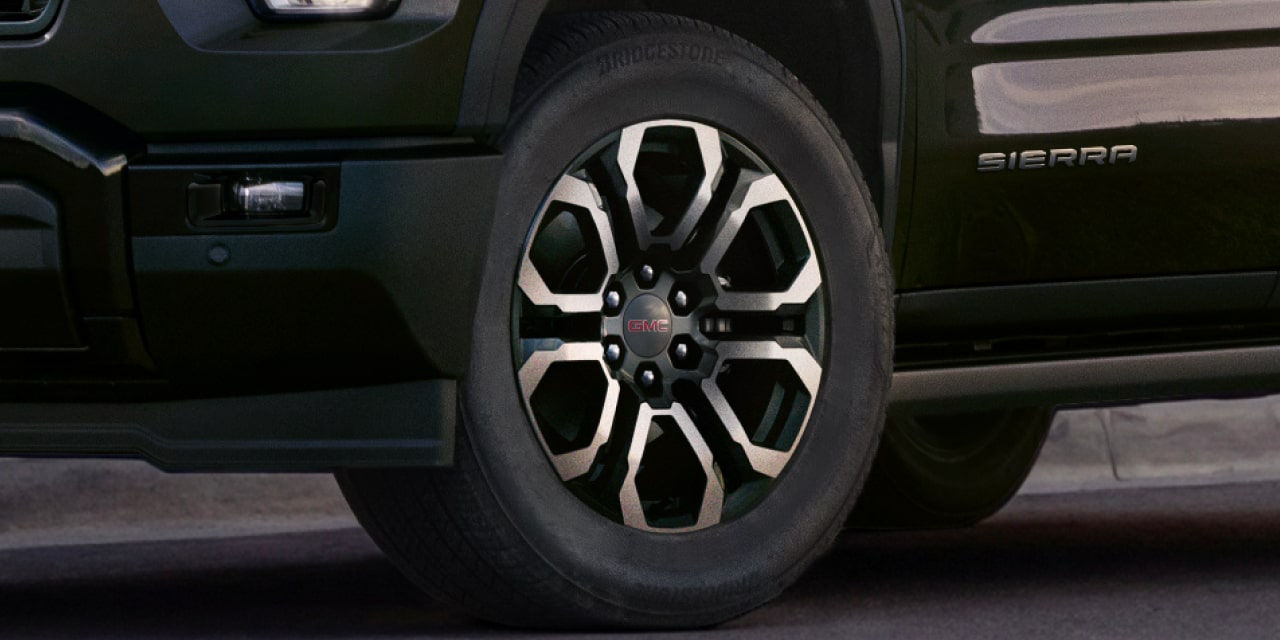 Gros plan sur une roue de GMC Sierra 1500 AT4X au design multibranche noir et argent