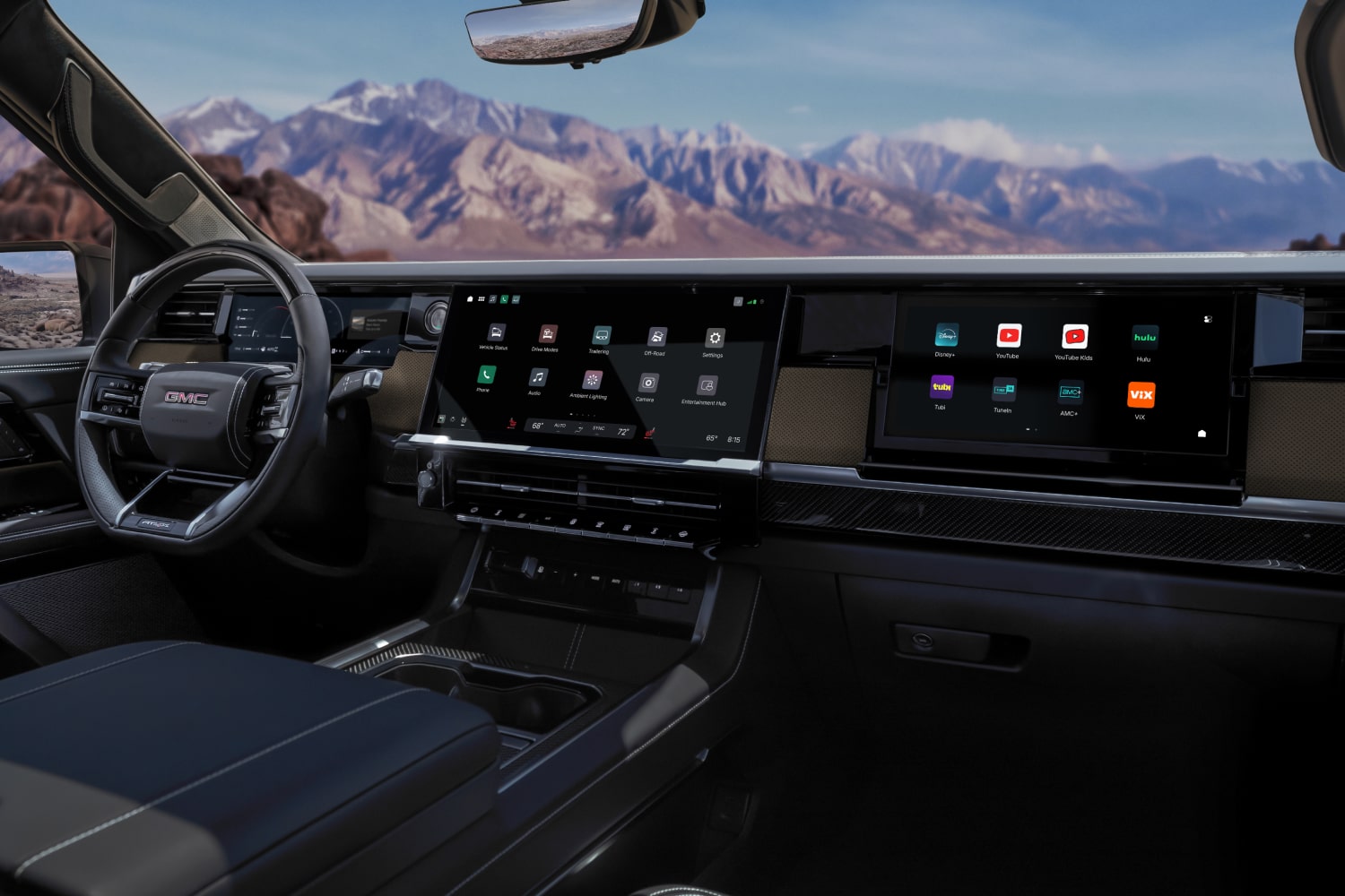 Vue de l’habitacle du GMC Sierra 1500 avec tableau de bord, large écran d’infodivertissement et paysage montagneux