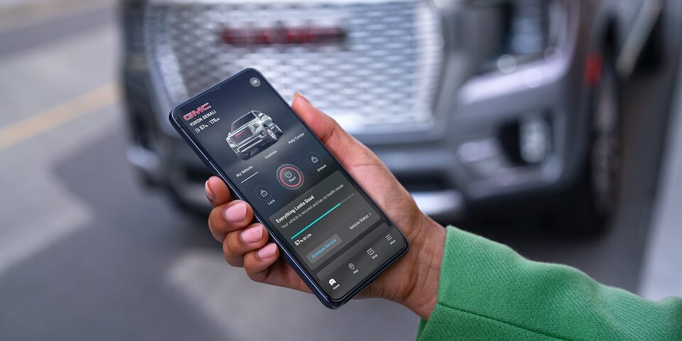 Close-up of a Woman Using the MyGMC Mobile App on her Smartphone
