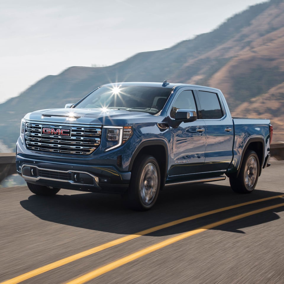 Front profile view of the 2025 GMC Sierra 1500 on the road.