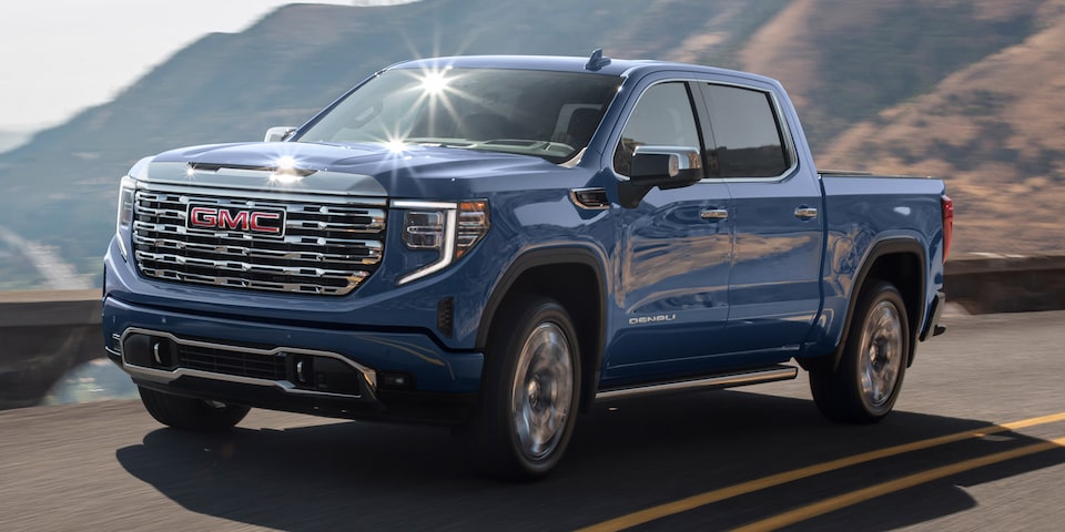 Front Three-Quarter View of a GMC Sierra 1500 Driving up a Winding Mountain Road
