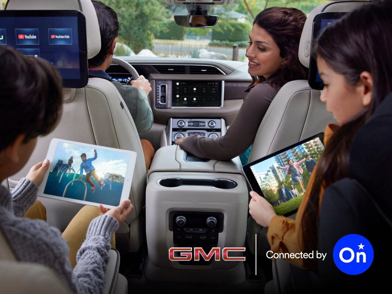 A Family of Four Embarking on a Road Trip in Their GMC Vehicle