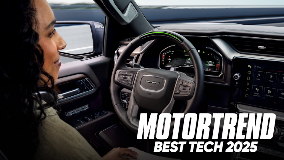 Over the Shoulder View of a Woman Using Super Cruise Hands-Free Technology in Her GMC with Text Overlay: MOTORTREND BEST TECH 2025