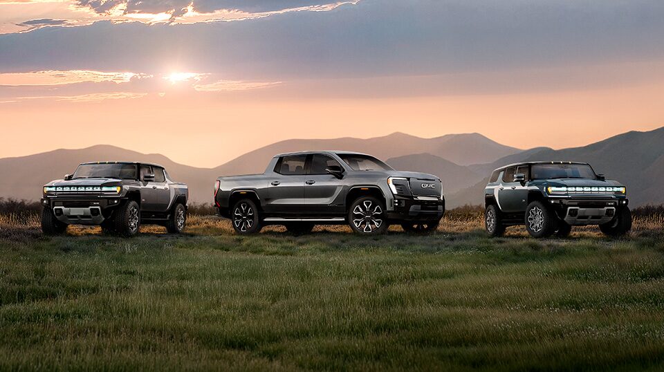 A Hummer EV Driving Off-road Through Mud