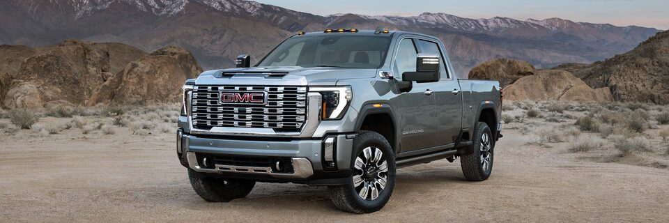 Wide Front Three-Quarters View of a GMC Sierra HD Denali Truck Parked in the Desert