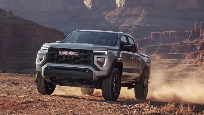 The Powerful GMC Canyon Elevation Driving Uphill on Dirt in a Desert