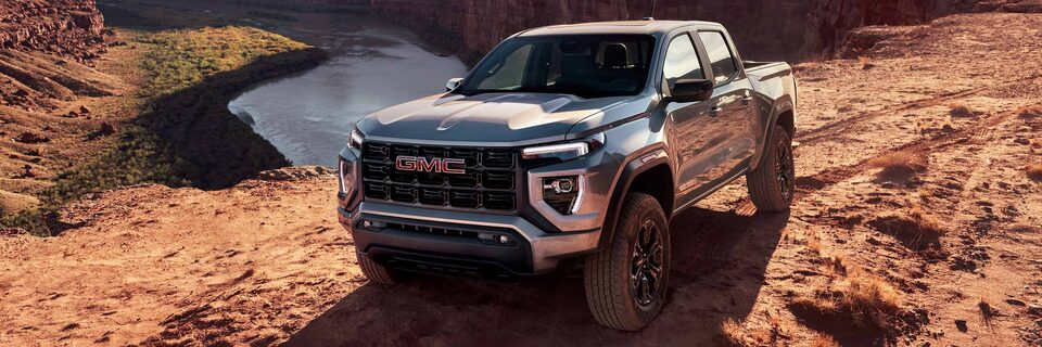 Three-quarters View of a 2025 GMC Canyon Truck Parked on a Rocky Desert Trail