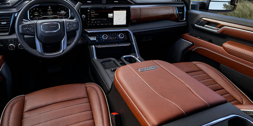 Close-up of the Front Seats, Center Console, Steering Wheel, and Infotainment System in a 2025 GMC Sierra HD Denali Truck