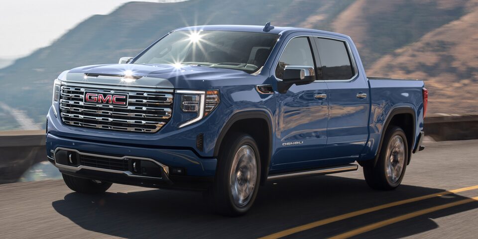 Front Three-Quarter View of a GMC Sierra 1500 Driving up a Winding Mountain Road