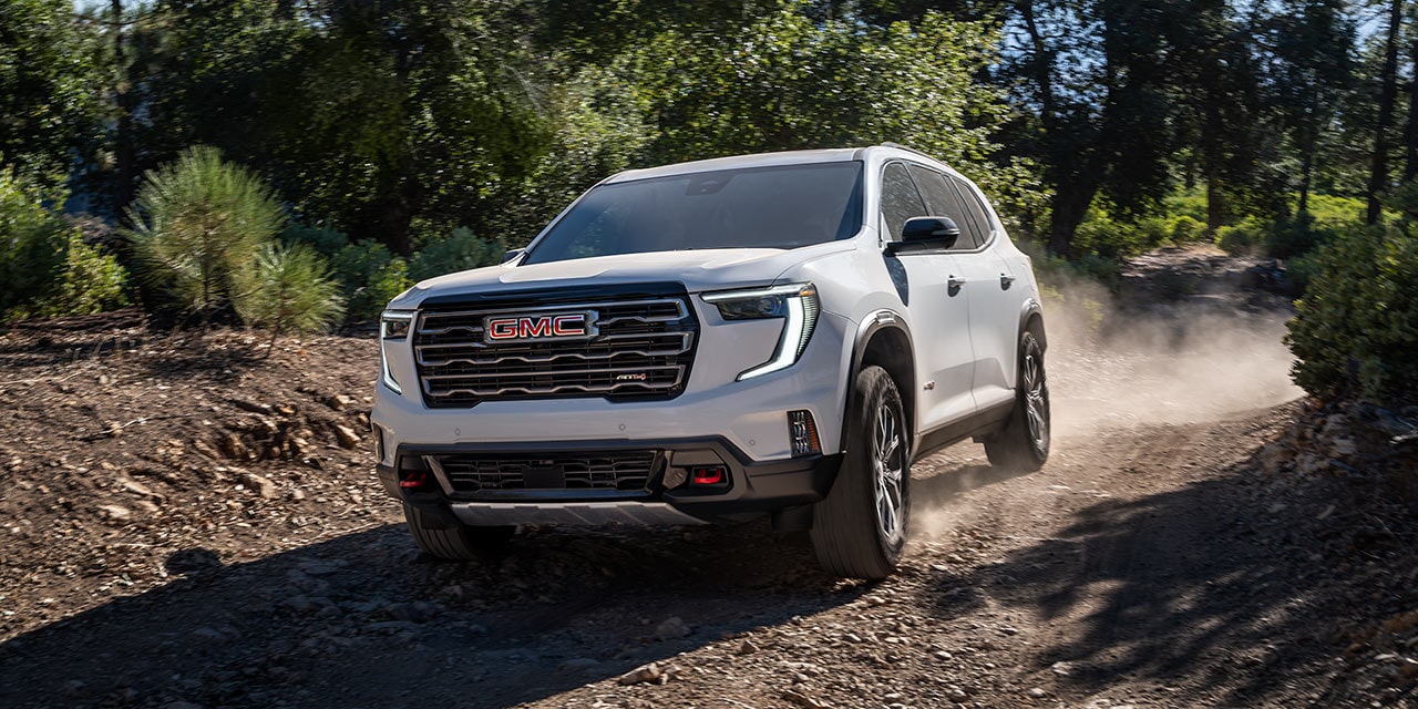 The GMC Acadia AT4 Mid-Size Off-Road SUV Driving Off-Road on a Sunny Day