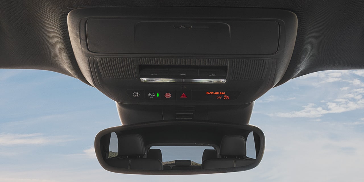 Close-up of the Driver Pressing the OnStar Button in Their GMC