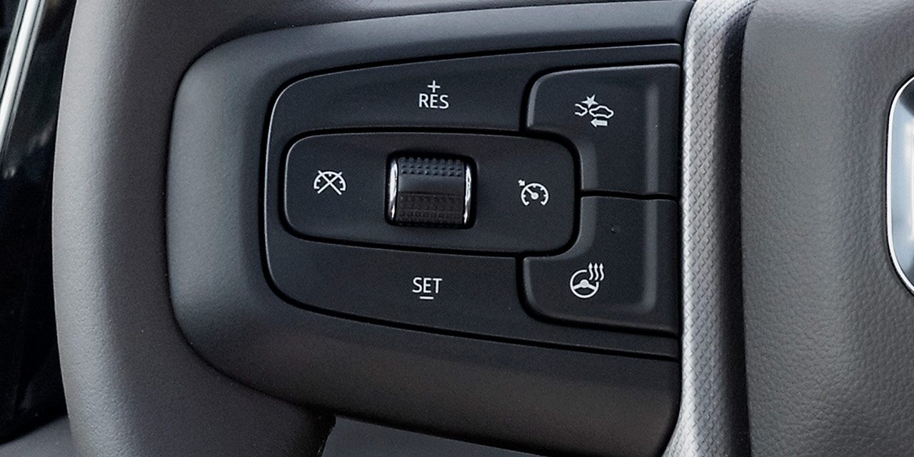 Close-up of the Adaptive Cruise Control with Trailering Controls on the Steering Wheel of the GMC Sierra HD Heavy Duty Truck