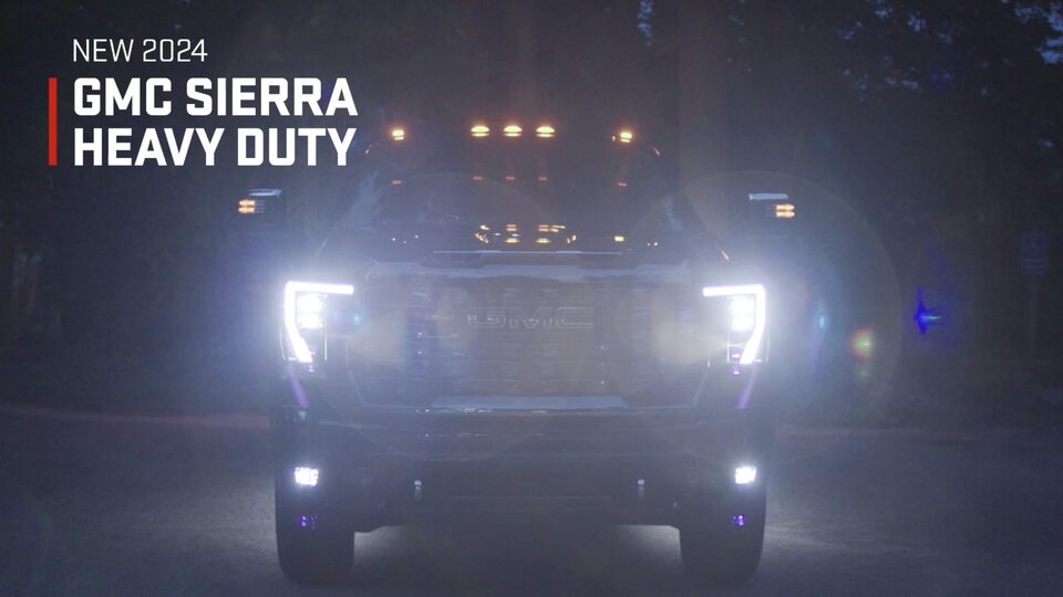The 2024 GMC Sierra HD on display with headlamps on.